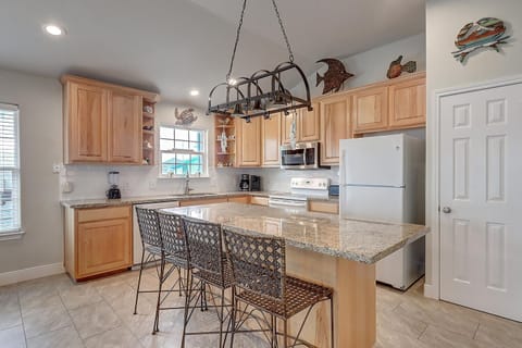Additional bar seating - Enjoy this bright, open kitchen with a generous island with seating for 4 — the perfect spot for easy meal prep and laid-back coastal living.