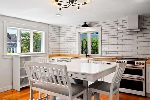 Counter height kitchen table/island seats 6+. GE Cafe double oven with glass cook top.