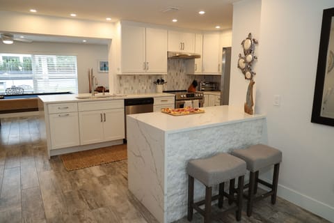Chef’s kitchen
-updated appliances, granite tops and bar stools on either side 
