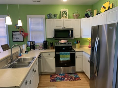 Kitchen area with new stainless steel appliances 