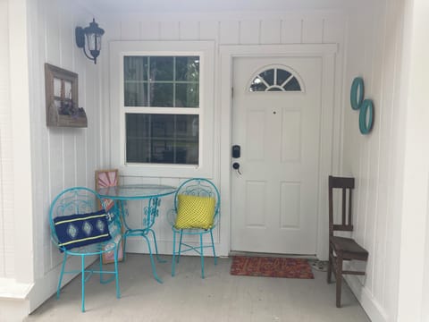 Small turquoise patio set at the entrance to the Rosa Linda. 
