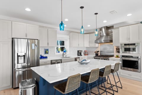 Your gourmet kitchen awaits with sparkling quartz counters, premium stainless appliances, and a stylish island perfect for morning coffee or evening wine.