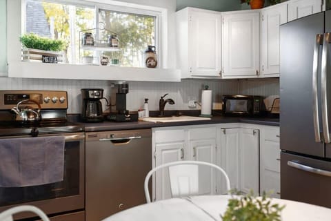 Fully equipped kitchen with updated appliances and 4 person dining table.