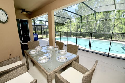 Large pool covered patio nature view.
