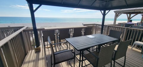 Deck Oasis: Enjoy your meals or coffee while enjoying the beach