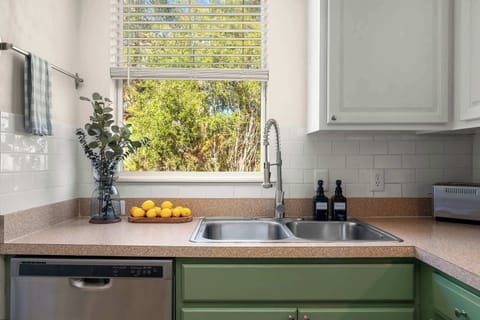 Enjoy green views from the kitchen window as you tend to your dishes easily with our dishwasher. The condo is located on the second floor of the building.