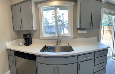 Sink side of the kitchen with backyard view