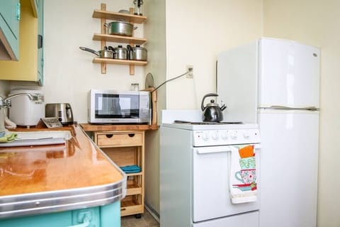 The kitchen boasts a small refrigerator, stove, and microwave perfect for this space