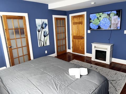Master bedroom with King Bed, smart TV, fireplace and private bathroom.  