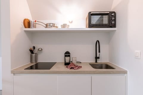 Compact kitchen with minimalist design and soft tones
