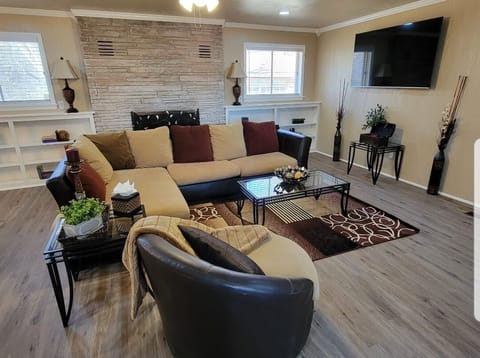 Spacious den with comfy sectional, swivel chair and 65" smart TV