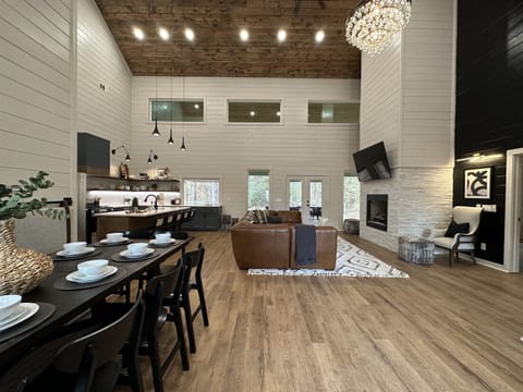 Welcome to Absolutely Still! The sofa is big enough for your whole crew and the table seats 10 - more if you can squeeze some kids on the bench!