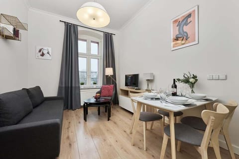 The living area features a sleek coffee table and a flat-screen television.