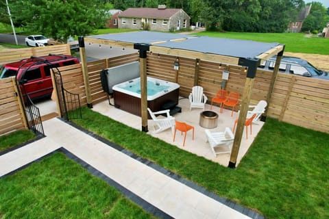 Slip into
the private hot tub
after dark — fire pit
glowing,
Adirondack chairs
waiting, fenced
yard all yours. This
is the shot guests
keep mentioning in
their five-star
reviews.

