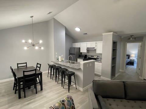 Open concept kitchen, stainless steel appliances.