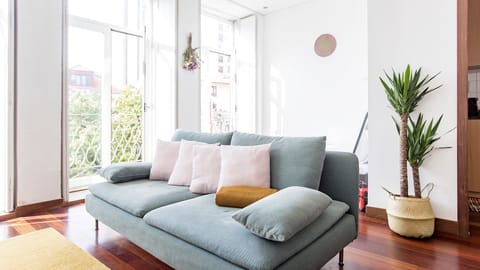 A bright living room filled with natural light, creating an airy and welcoming atmosphere throughout the day.

#PortoStay #AirbnbPorto #BrightLiving #CityComfort