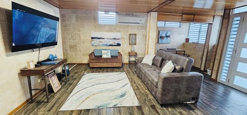 Open living space with air conditioning, smart TV, Wi-Fi and ceiling fans.