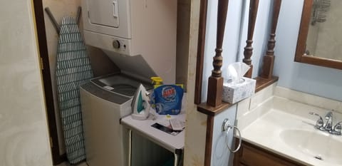 Whirlpool washer/dryer, iron, ironing board & table are in the large bathroom. 
