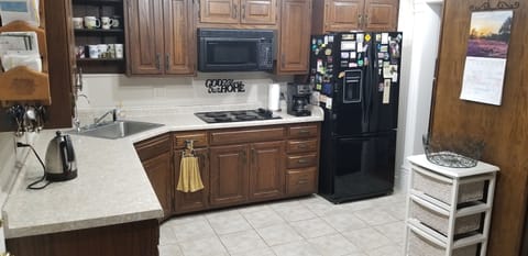 Cook with microwave, counter-top stove, wall oven and crock pot. Custom cabinets
