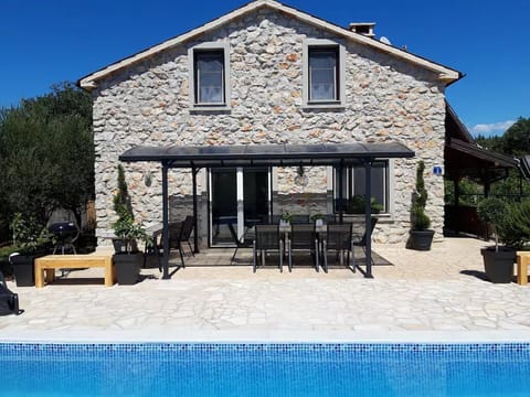 Pool, pergola, and poolside seating of Casa Nora Adriatica.