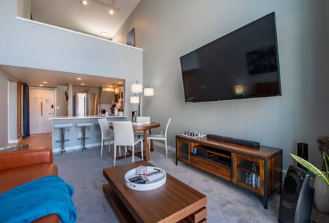 Living Room with a Large 75" TV, Vaulted Ceiling Windows & Sleeper Sofa