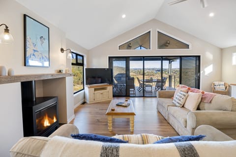 Beautiful open plan living, with wooden floors, pitched roof and gas wood burner
