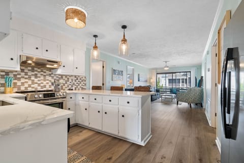 Updated and fully stocked kitchen with new lighting and backsplash
