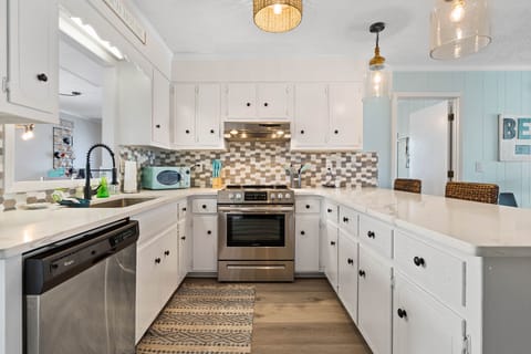 Freshly painted fully stocked kitchen w/ quartz counters and newer appliances.