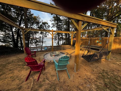 Swing while enjoying the water and fire pit.