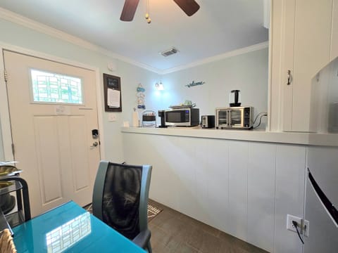 Kitchenette microwave, Keurig, toaster, and mini air fryer oven, electric kettle and double burners are all provided along with a few pans & cooking utensils. A small supply of plastic eating utensils & paper products are provided as well. No kitchen sink.