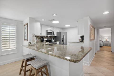 Kitchen with Granite Countertops, Stainless Steel Appliances and Bar Stool Seating for Two