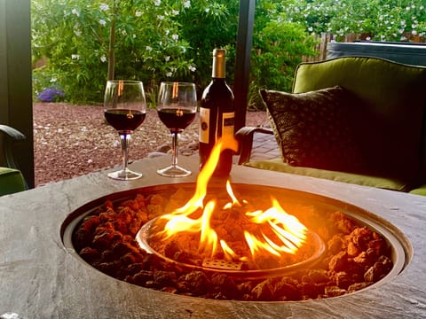 Relax at the covered back patio w/Fire pit and nearby hot tub
