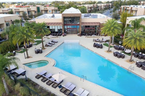 Sparkling pool and spa outside the clubhouse with sun loungers and dining areas-perfect for an afternoon dip and easy relaxation.