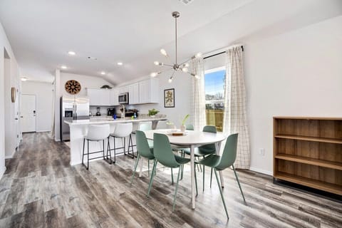 Next to the living room, you'll see our 6-top dining table and kitchen.