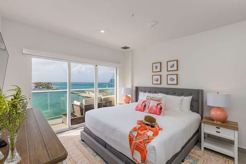 Wake up to stunning turquoise waters and tropical breezes. Your seaside sanctuary features a plush king bed, private balcony, and coastal decor that brings the beach indoors.