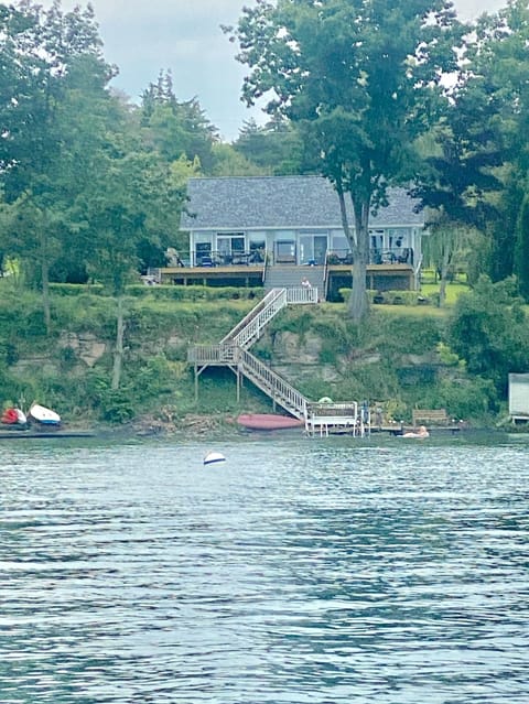 The house, beach, kayaks, and private dock.