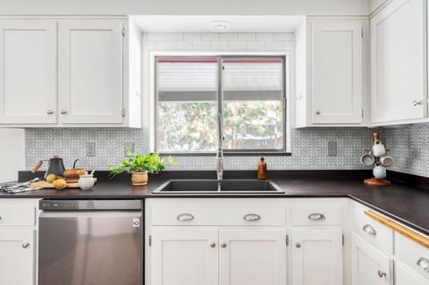 Kitchen houses modern appliances.