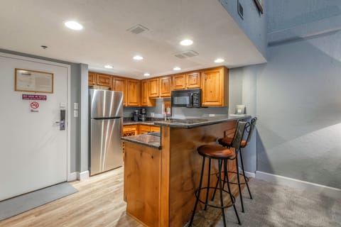 Fully Equipped Kitchen with stone countertops, GE appliances, and bar seating for two