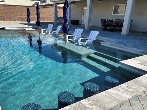 Extra large 20' tanning shelf, in pool cocktail table, & 4 barstools.