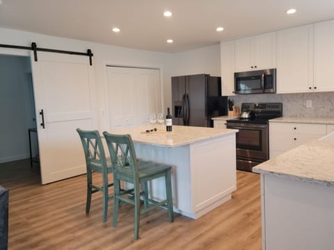 Open floor plan kitchen area. Full size refrigerator with ice and water.