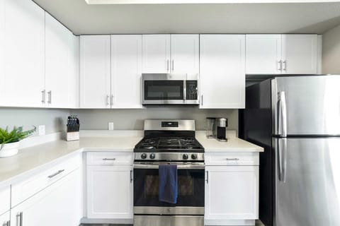 Whip up meals with ease in this sleek kitchen featuring stainless steel appliances and plenty of prep space. 