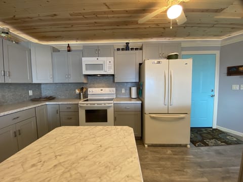 Modern kitchen well equipped with many spices and cooking items