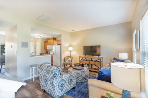 Living room with attached kitchen and dining room. Looking from front door 