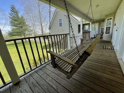 Back porch swings, perfect for a nice cup of coffee or tea watching the horses!