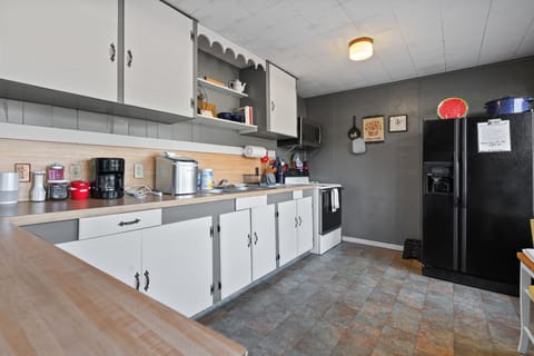 Coffee maker, ice maker, oven, maker, toaster, blender, microwave, and utensils 