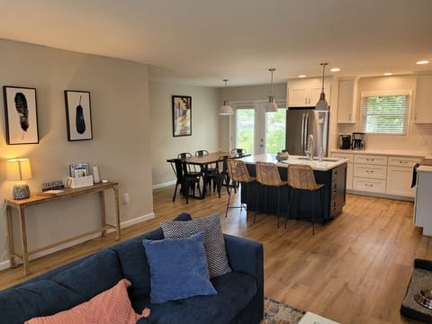 LIVING ROOM:  The living room features a cozy sectional that unfolds into a double bed.  There is also a coffee table, hutch, ceiling fan, a couple portable chairs, a dog bed, and a large smart TV.