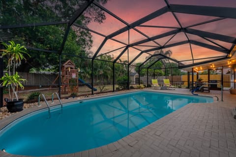 Immerse yourself in pure bliss at this backyard pool, where the sun bids farewell in a mesmerizing display.