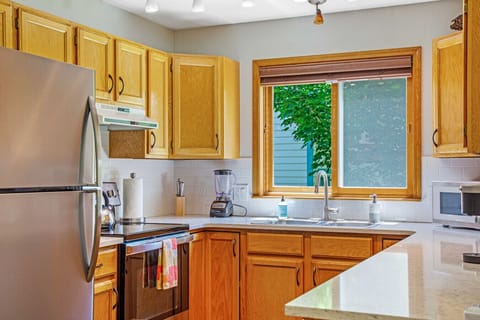 Kitchen with quartz countertops, oven/range, dishwasher, microwave, coffee maker, Keurig, toaster, blender, kitchen and dinnerware.