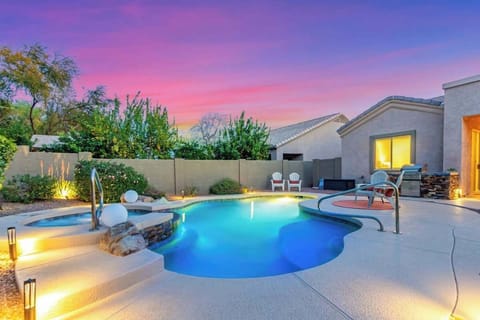 Perfectly manicuredd back yard oasis with sparkling play pool with spa