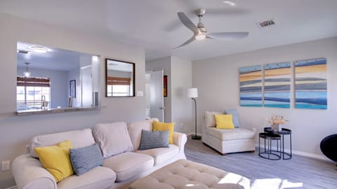 Living room with rear door (with doggie door) to backyard, fireplace, and TV